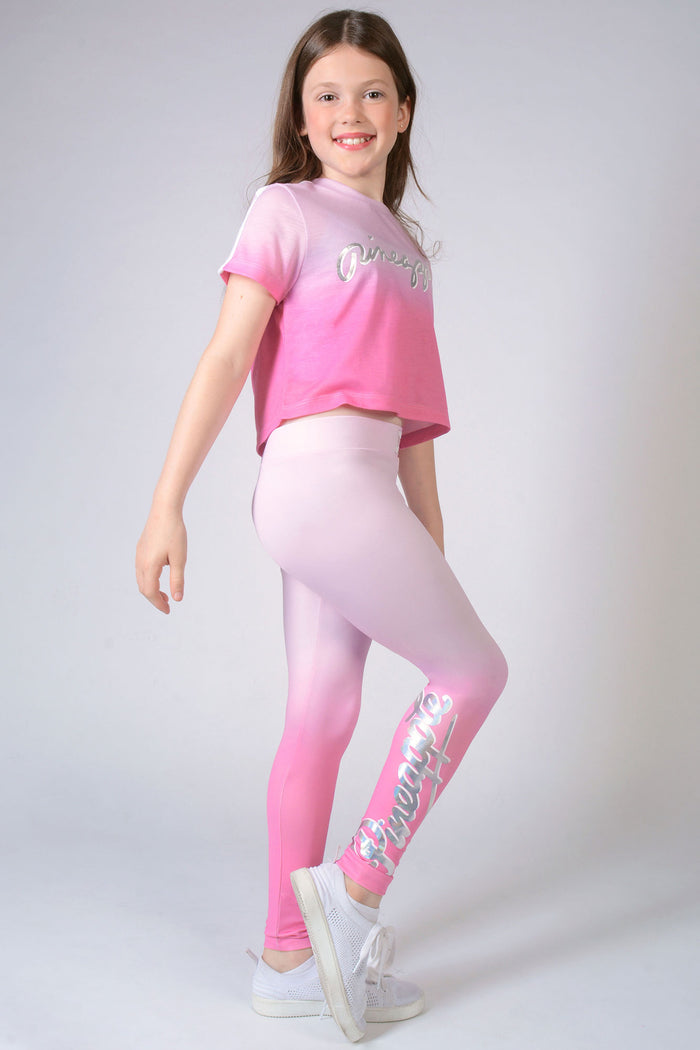 Girl wearing candyfloss pink Ombré Leggings with silver logo and matching cropped length  t-shirt
