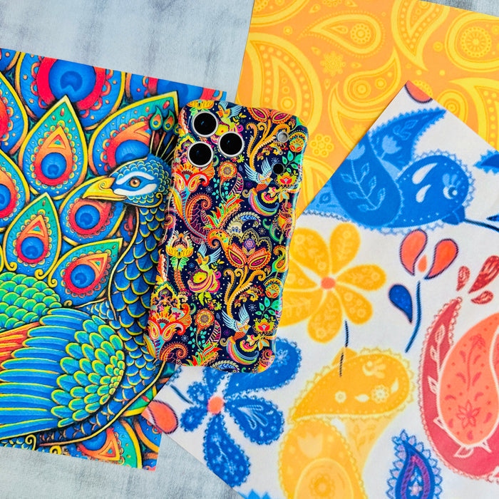 Paisley Birdsong Wavy Luxe MagSafe iPhone case styled against bright yellow and blue paisley and peacock artwork.