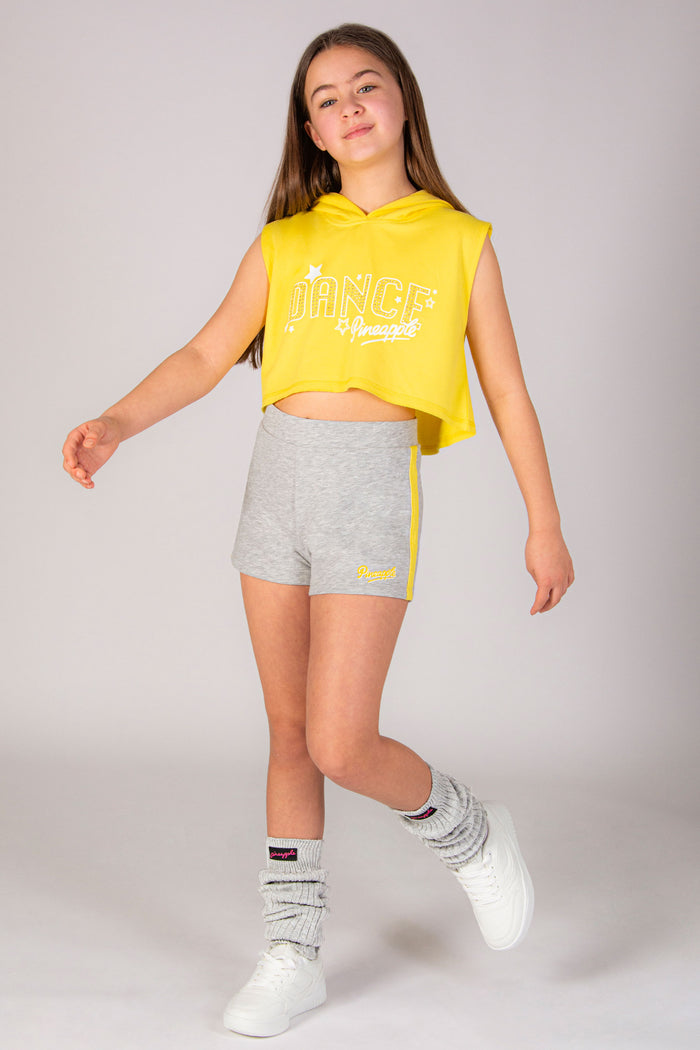Girls' grey sports shorts with yellow stripe and small Pineapple Dance Studios logo