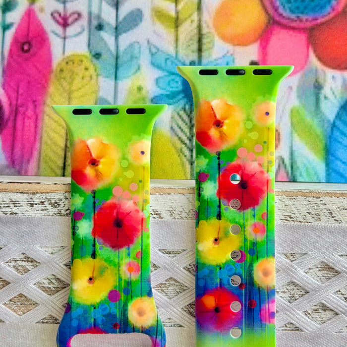Petal Princess Apple Watch band with vibrant watercolor flowers in red, orange, yellow, pink, and blue on green background