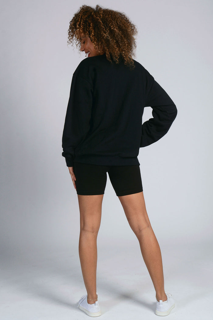Woman wearing black Unisex Sweat Top and shorts