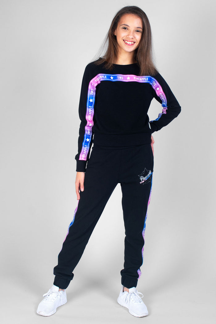 Girl wearing black TNS Tape Sweat Top and TNS Tape Joggers