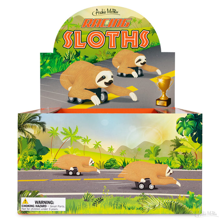 The packaging for Racing Sloths features sloths on skateboards against a lively tropical backdrop, inclusive of a caution label. Made from soft vinyl, these wheeled speedsters are ideal for those who enjoy fun and adventure.