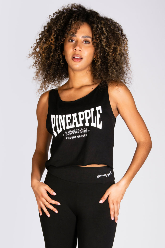 Women's black crop top with London Covent Garden chest print in white.