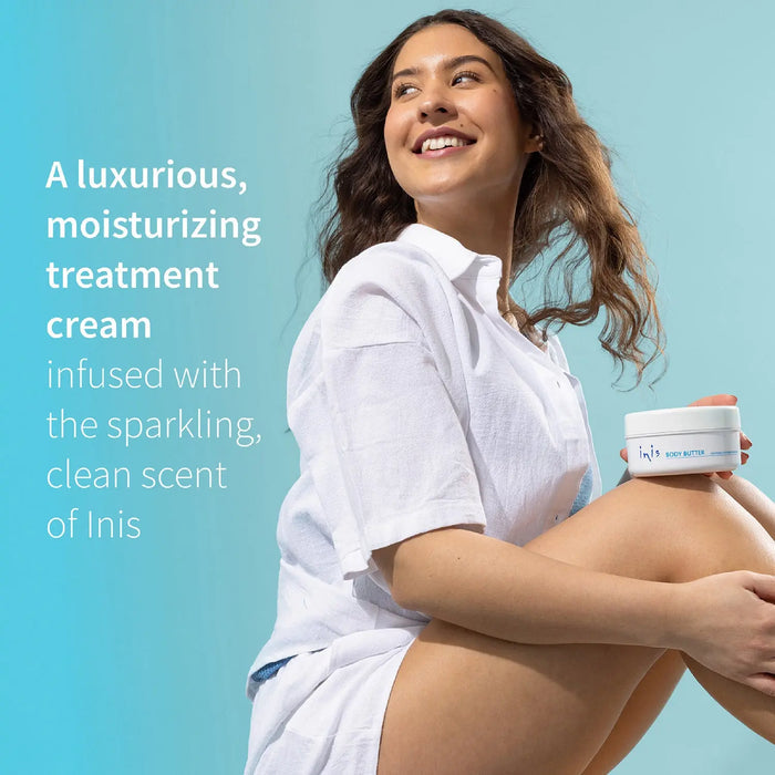 Woman holding a white jar of Inis moisturizing body butter against a blue background