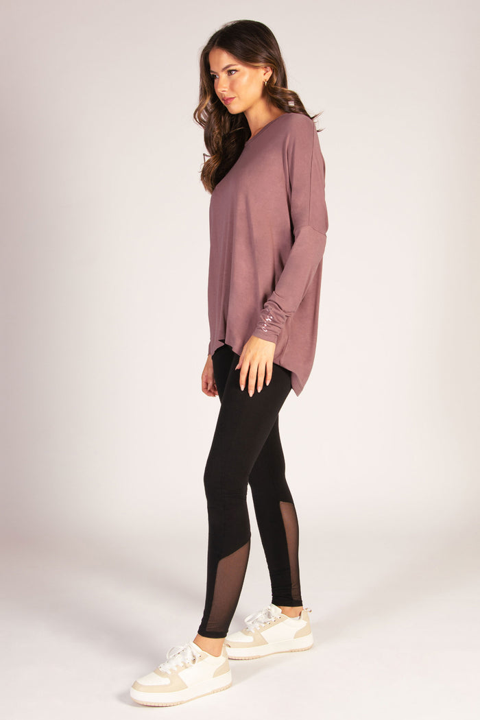 Dark brown long sleeve top for women featuring soft jersey fabric and dipped back.