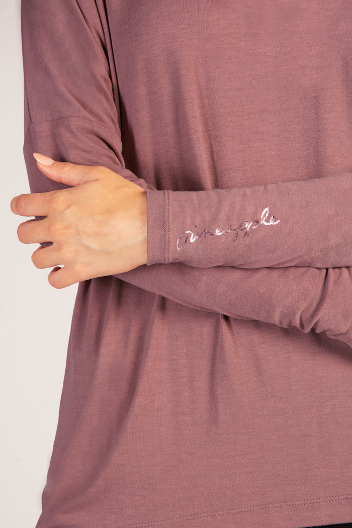 Detail shot of small Pineapple Dance Studios branding on the sleeve in rose gold foil.