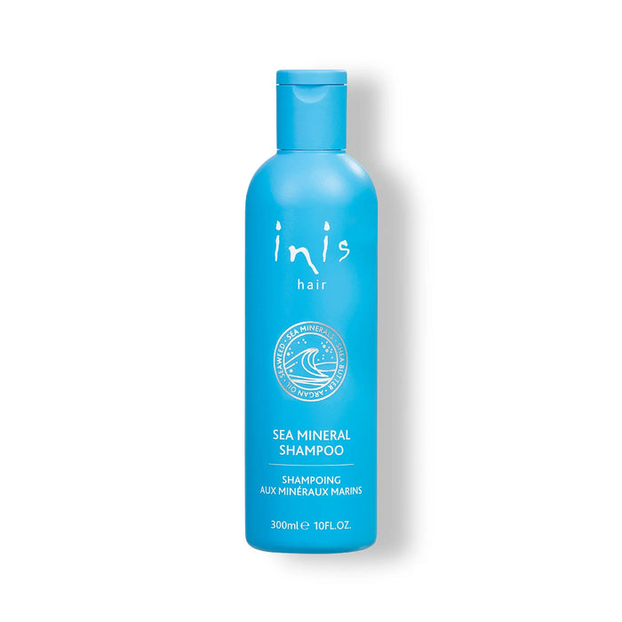 Blue shampoo bottle with 'inis hair' branding on a white background