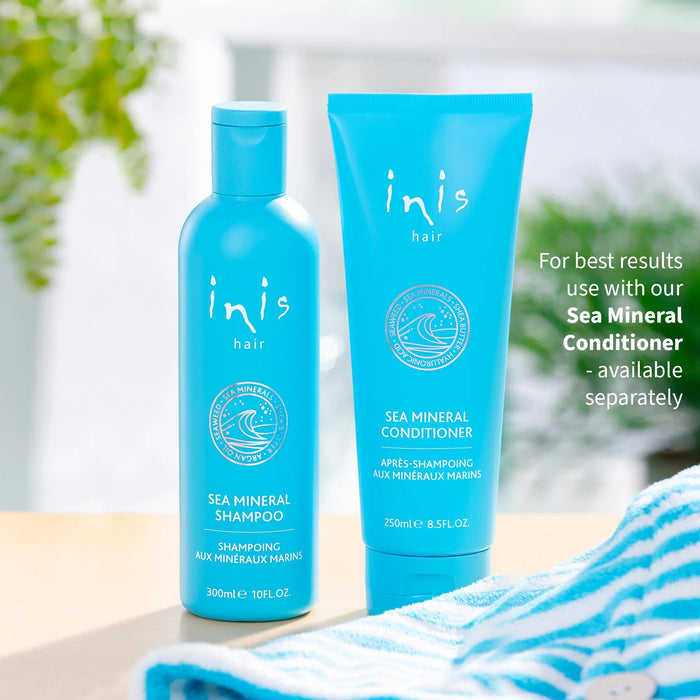 Two blue hair care products with 'inis' branding on a blurred natural background