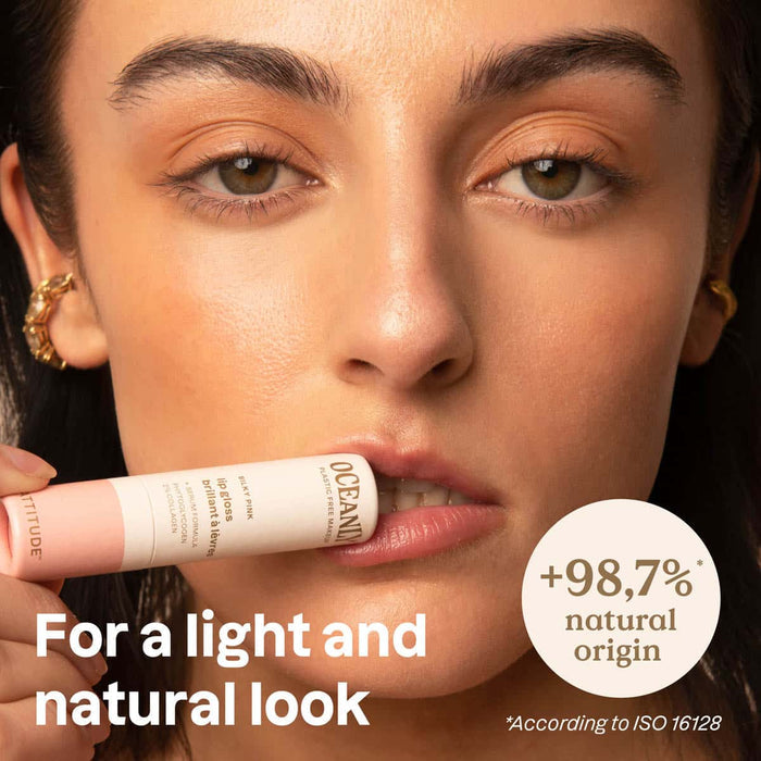 Woman holding a makeup product with text about natural origin.