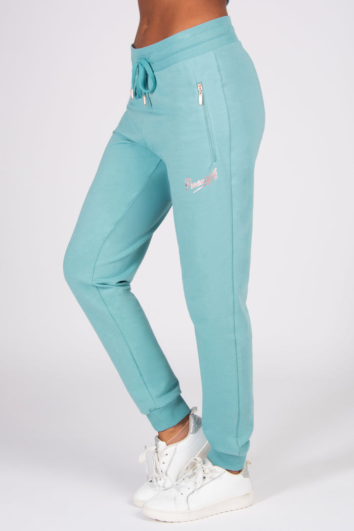 Teal jogger pants with a brand logo on a white background