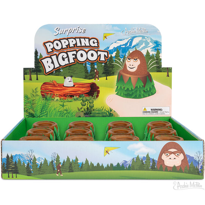 A package of Surprise Popping Bigfoot toys is displayed, showcasing a forest-themed background along with a cartoonish Bigfoot design. These charming rubber toys are an exciting addition to any collection.
