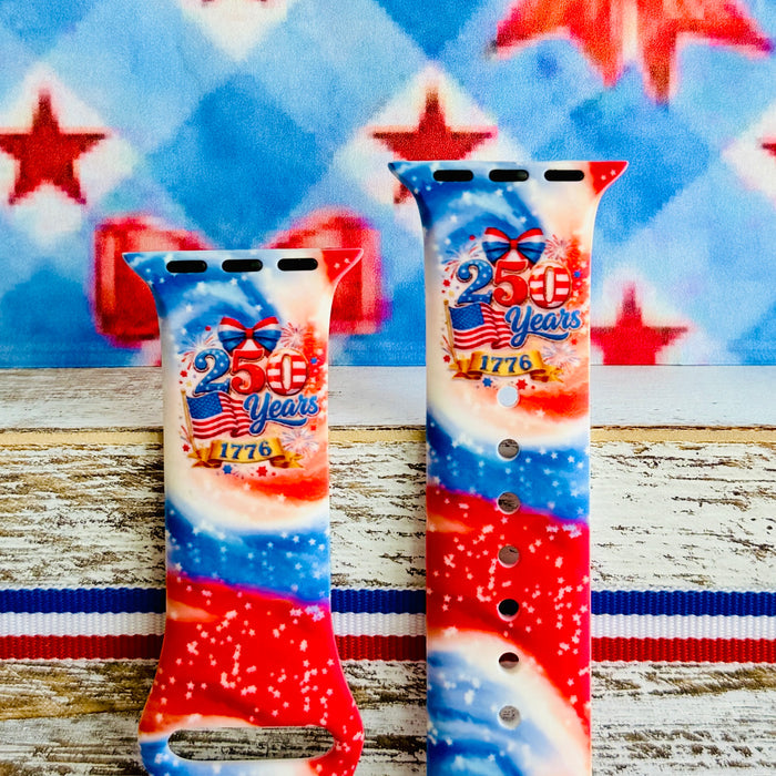 Sweet Freedom 250 silicone Apple Watch band celebrating America's 250th anniversary with "250 Years 1776" emblem, American flag, fireworks, red bow, and red, white, and blue tie-dye swirl with star sparkle, shown displayed and worn on Apple Watch against a patriotic 4th of July backdrop.