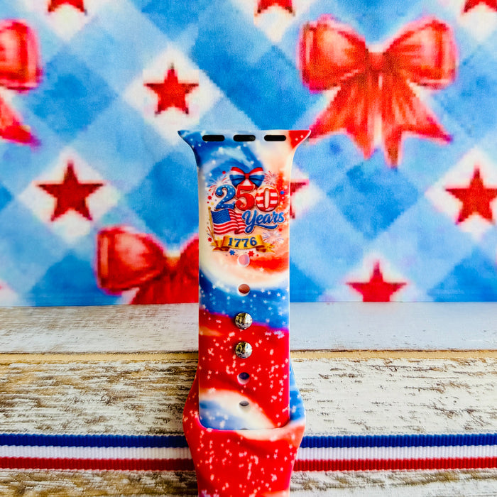 Sweet Freedom 250 silicone Apple Watch band celebrating America's 250th anniversary with "250 Years 1776" emblem, American flag, fireworks, red bow, and red, white, and blue tie-dye swirl with star sparkle, shown displayed and worn on Apple Watch against a patriotic 4th of July backdrop.
