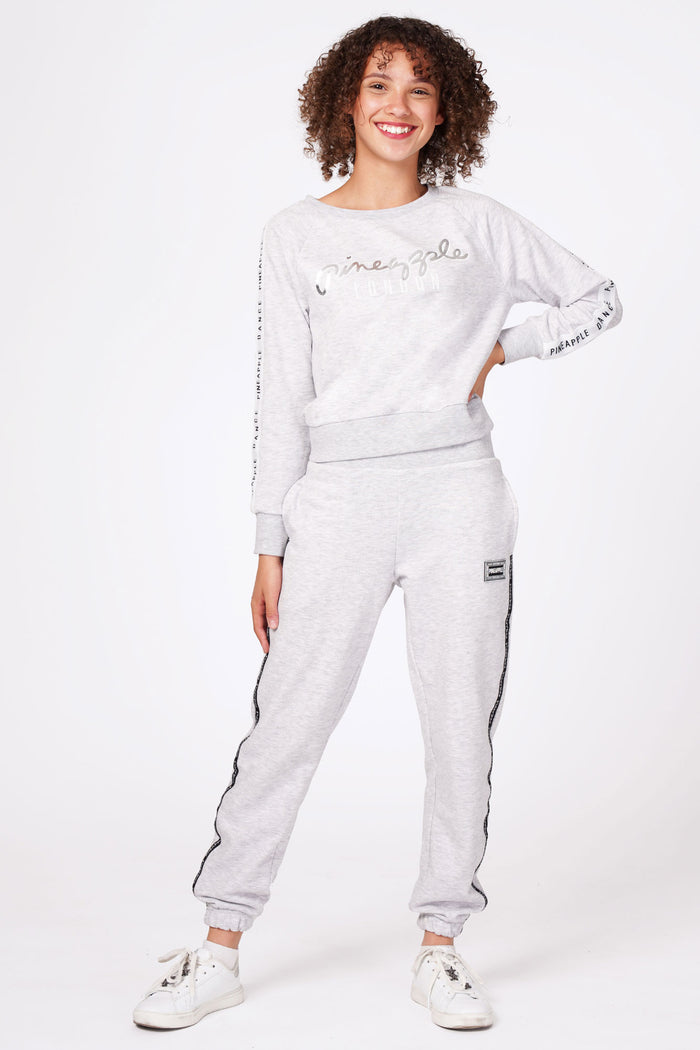 Girl wearing Grey Tape Joggers and grey sweater
