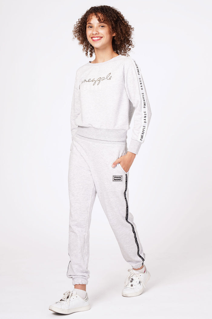 Girl wearing Grey Tape Joggers and grey jacquard sweater