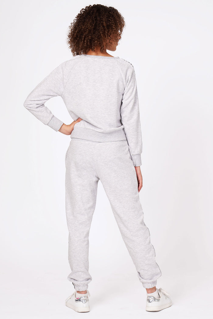 Girl wearing Grey Tape Joggers and matching grey sweater