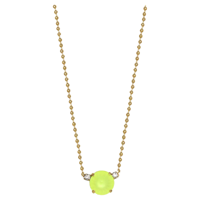 Neon green pendant on a gold chain against a white background
