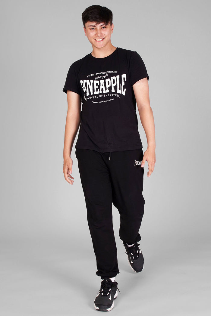 Man wearing Unisex Black T-Shirt and black joggers