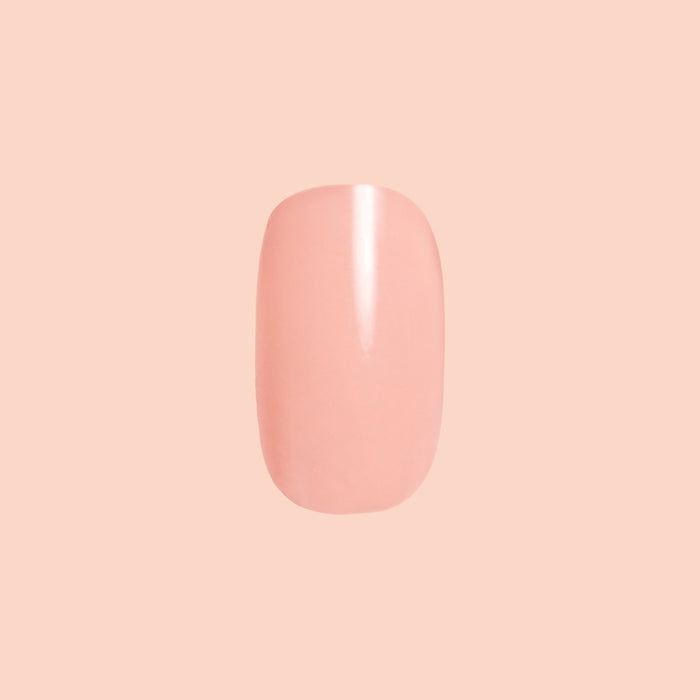 Single extra short squoval press-on nail in coral from Wild & Free | Squoval | Extra Short for easy at-home manicure