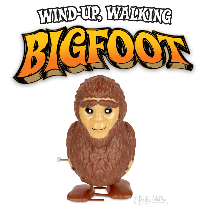 The Wind-Up Bigfoot vinyl figure features a wind-up key and is highlighted under the bold text "Wind-Up Bigfoot." Ideal for collectors, this toy can be stored in its illustrated display box.